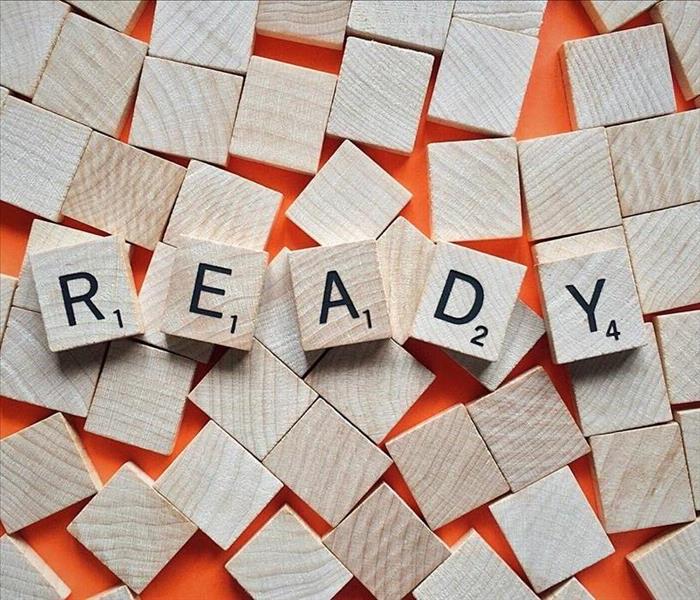Scrabble tiles spelling out the word "ready".