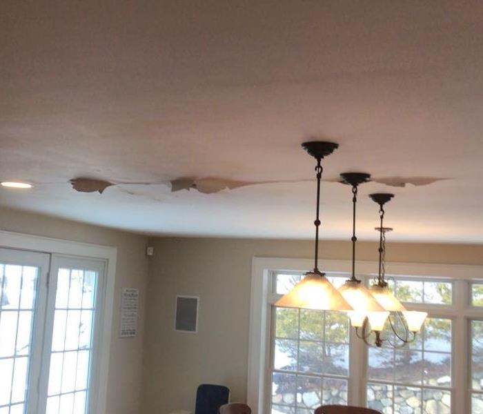 Photo of damp ceiling as a result of unrepaired water damage.